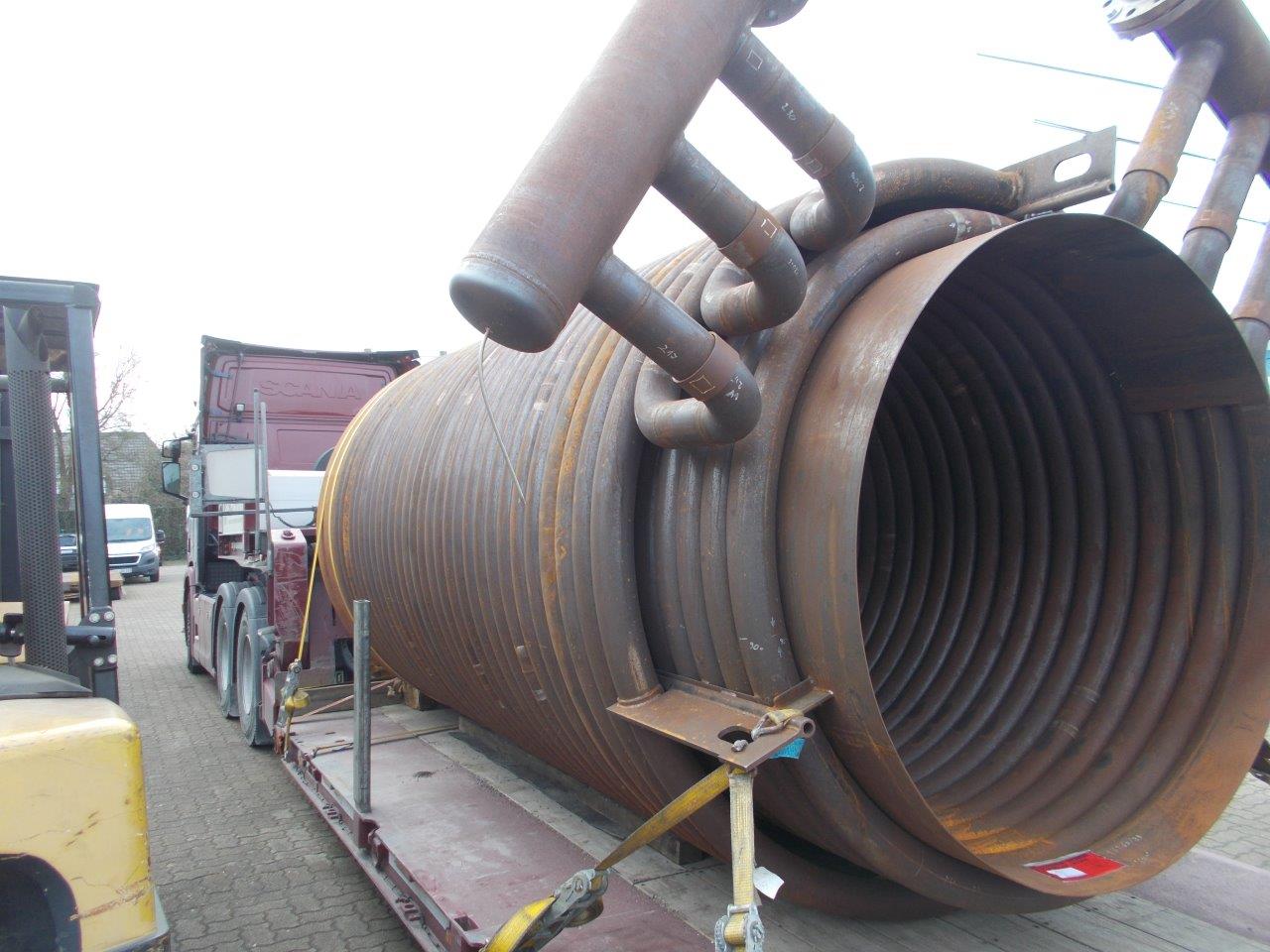 Industrial heat exchanger coil loaded on a low-bed trailer at the HAF premises in Hamburg